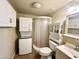 Bathroom features a stand up shower, stacked washer and dryer, and built in storage at 1044 S Quartz Dr, Apache Junction, AZ 85119