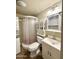 This bathroom includes a stand up shower, white vanity, and a stacked washer/dryer at 1044 S Quartz Dr, Apache Junction, AZ 85119