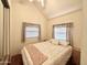 Cozy bedroom with large mirrored closet and two bright windows at 1044 S Quartz Dr, Apache Junction, AZ 85119