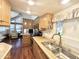Eat-in kitchen features wood cabinets, updated appliances, and a double sink at 1044 S Quartz Dr, Apache Junction, AZ 85119