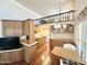 Full kitchen view with laminate floors, wood cabinetry, and dining area at 1044 S Quartz Dr, Apache Junction, AZ 85119