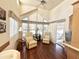 Bright living room features vaulted ceilings, many windows, and wood-look floors at 1044 S Quartz Dr, Apache Junction, AZ 85119