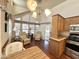 Cozy living room features vaulted ceilings, many windows, and wood-look floors at 1044 S Quartz Dr, Apache Junction, AZ 85119