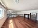 Open loft space with laminate floors, shelving, and clerestory windows at 1044 S Quartz Dr, Apache Junction, AZ 85119