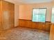 Bedroom featuring wall to wall carpet, wooden paneling, and large window with natural light at 8103 E Southern Ave # 24, Mesa, AZ 85209