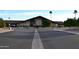 A beautiful community clubhouse featuring lush landscaping and palm trees and ample parking at 8103 E Southern Ave # 24, Mesa, AZ 85209