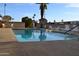 Inviting community pool featuring lounge chairs, umbrellas, and clear blue water for relaxation at 8103 E Southern Ave # 24, Mesa, AZ 85209