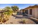 Cactus and palm trees accent the gravel yard with a patio and built-in BBQ at 17156 W Lachlan Ct, Surprise, AZ 85387
