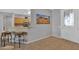 Entryway with kitchen view, tile floors and two brown stools at 17156 W Lachlan Ct, Surprise, AZ 85387
