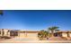 Tan three-car garage with desert landscaping at 17156 W Lachlan Ct, Surprise, AZ 85387