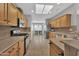 Kitchen with light wood cabinets, stainless steel appliances, and tile flooring at 17156 W Lachlan Ct, Surprise, AZ 85387