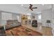 Living room with grey couches, a brown chair and a large area rug at 17156 W Lachlan Ct, Surprise, AZ 85387