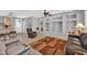 Living room with built-in shelving and a large area rug at 17156 W Lachlan Ct, Surprise, AZ 85387