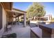 Extended covered patio, with seating and a grill at 17156 W Lachlan Ct, Surprise, AZ 85387