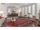 Living room with ornate rug and view into the dining room at 7291 N 71St Pl, Paradise Valley, AZ 85253