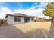 A side angle view of the backyard, gravel, block fence, house at 17463 N 66Th Ave, Glendale, AZ 85308