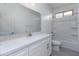 Bright bathroom with modern vanity and tiled shower-tub combination at 17463 N 66Th Ave, Glendale, AZ 85308