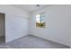 Bright bedroom with a window and a closet with white sliding doors at 17463 N 66Th Ave, Glendale, AZ 85308