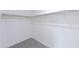 A bright walk-in closet with carpet, white walls and basic metal hanging racks at 17463 N 66Th Ave, Glendale, AZ 85308