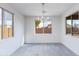 Bright dining room filled with natural light, featuring tile floors and contemporary chandelier at 17463 N 66Th Ave, Glendale, AZ 85308