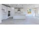 Bright, open kitchen features white cabinets, stainless steel appliances, and a large center island at 17463 N 66Th Ave, Glendale, AZ 85308