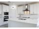 Modern kitchen boasts white cabinets, stainless steel appliances, and a large center island at 17463 N 66Th Ave, Glendale, AZ 85308