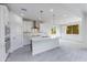 Bright, open kitchen features white cabinets, stainless steel appliances, and a large center island at 17463 N 66Th Ave, Glendale, AZ 85308