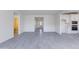 Bright, open-concept living room featuring gray tile floors and access to the kitchen and a full bath at 17463 N 66Th Ave, Glendale, AZ 85308