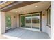 A covered patio with a sliding glass door and an entry door at 17463 N 66Th Ave, Glendale, AZ 85308