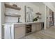Elegant bar area with modern cabinetry, wine fridge, and floating shelves at 12297 E Troon Vista Dr # 255, Scottsdale, AZ 85255