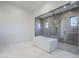 Modern bathroom featuring a soaking tub and separate shower with gray tiles and pebble floor at 12297 E Troon Vista Dr # 255, Scottsdale, AZ 85255