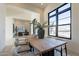 Dining room with modern decor, light wood floors, large black framed windows, and recessed lighting at 12297 E Troon Vista Dr # 255, Scottsdale, AZ 85255