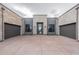 Modern desert home with stone facade, black garage doors, and concrete driveway at 12297 E Troon Vista Dr # 255, Scottsdale, AZ 85255