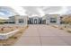 A modern desert home with a long driveway and manicured landscape at 12297 E Troon Vista Dr # 255, Scottsdale, AZ 85255