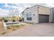 Modern desert home with stone facade, black garage door, and professional landscaping at 12297 E Troon Vista E Dr, Scottsdale, AZ 85255