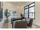 Home office with modern decor, light wood floors, and large black framed window at 12297 E Troon Vista Dr # 255, Scottsdale, AZ 85255