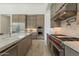 Bright kitchen featuring an island with sink, stainless steel appliances and custom cabinetry at 12297 E Troon Vista Dr # 255, Scottsdale, AZ 85255