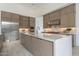 Modern kitchen with a large island, stainless steel appliances, and custom cabinetry at 12297 E Troon Vista Dr # 255, Scottsdale, AZ 85255