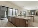 Open concept kitchen boasting an expansive island flowing to the outdoor living area at 12297 E Troon Vista Dr # 255, Scottsdale, AZ 85255