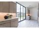 Kitchen with counter seating and modern backsplash with outdoor view at 12297 E Troon Vista Dr # 255, Scottsdale, AZ 85255