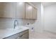 Modern laundry room features built in cabinets and quartz countertops at 12297 E Troon Vista Dr # 255, Scottsdale, AZ 85255