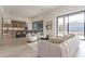 Bright open-concept living area connecting a living room, kitchen, and outdoor pool at 12297 E Troon Vista Dr # 255, Scottsdale, AZ 85255