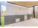A well-appointed outdoor kitchen boasts stainless steel appliances, counter seating, and stylish finishes at 12297 E Troon Vista Dr # 255, Scottsdale, AZ 85255