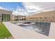 Backyard featuring a luxurious pool, modern patio, and outdoor kitchen with mountain views at 12297 E Troon Vista Dr # 255, Scottsdale, AZ 85255
