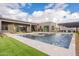 Beautiful backyard with a sparkling pool, outdoor kitchen, and modern architecture at 12297 E Troon Vista Dr # 255, Scottsdale, AZ 85255