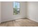 This bedroom features wood-look floors, a neutral color scheme, and a window offering natural light at 18450 E Camila Dr, Gold Canyon, AZ 85118