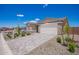 Inviting home featuring a paved driveway, well-maintained landscaping, and a large garage at 18450 E Camila Dr, Gold Canyon, AZ 85118