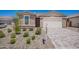 Charming single-Gathering home featuring a well-maintained front yard with desert landscaping and a brick paved driveway at 18450 E Camila Dr, Gold Canyon, AZ 85118