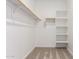 Walk-in closet features carpeted flooring and white shelving for organized storage at 18450 E Camila Dr, Gold Canyon, AZ 85118