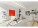 Open living room area with white decor, colorful artwork, and modern shelving displays at 312 E Windsor Ave # 14, Phoenix, AZ 85004